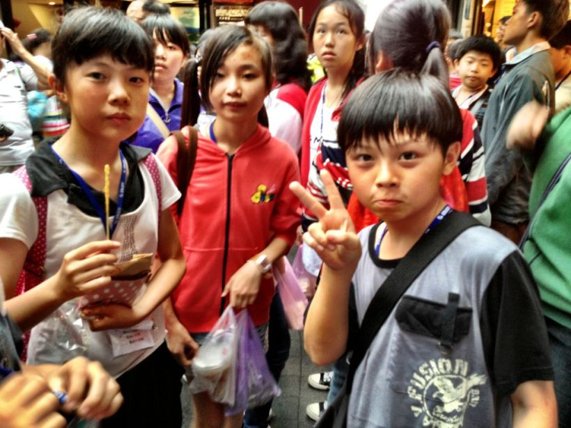 School kids saying Hi! THe ubiquitous 'peace' sign