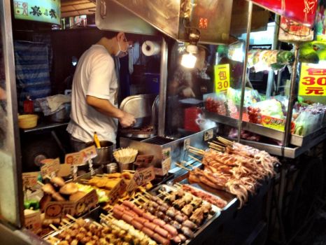 The safe BBQ stall, pork wrapped around broccoli and squid, all cut up and placed in a  bag with chilli sauce