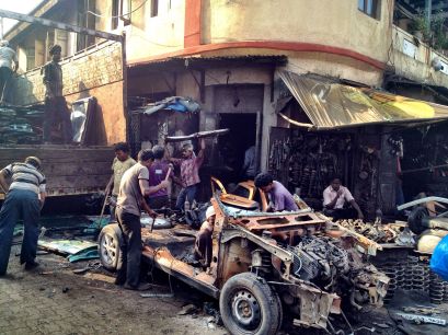 Stripping a car down to its component parts in Chor Bazaar