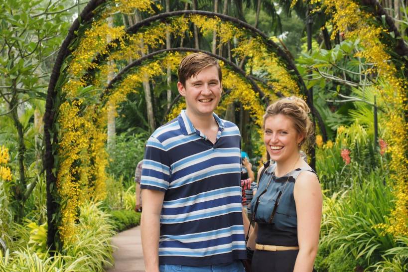 Tommy and Olivia under a bower of yellow orchids