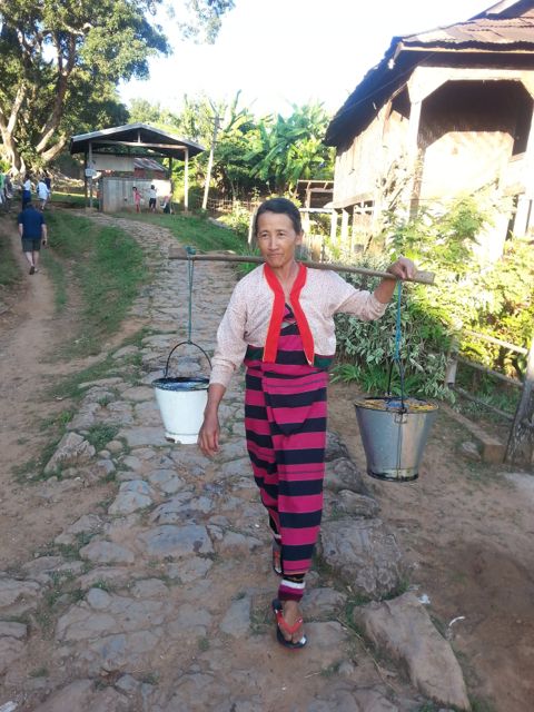 Mama brings water from the UNICEF  well - there is no running water