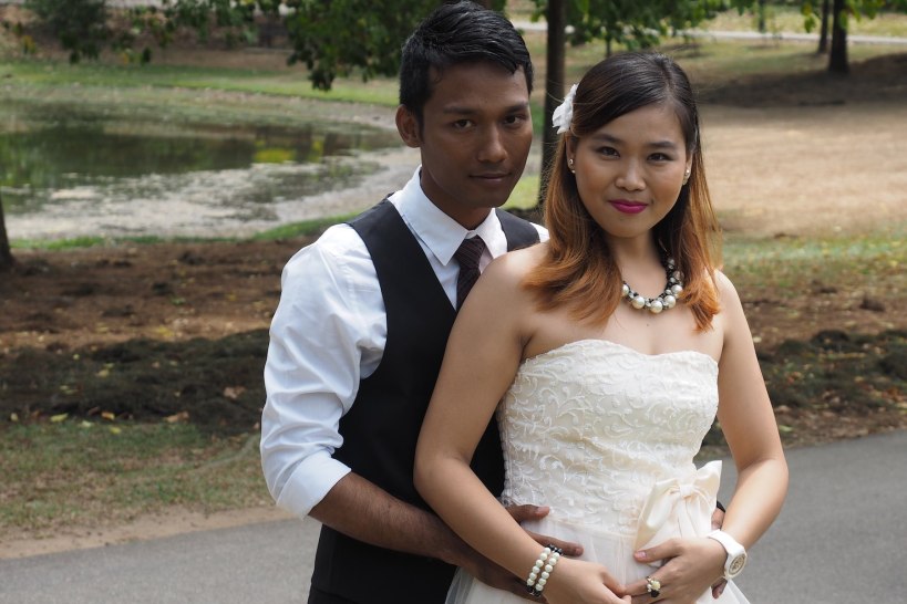 A wedding couple posing for photos