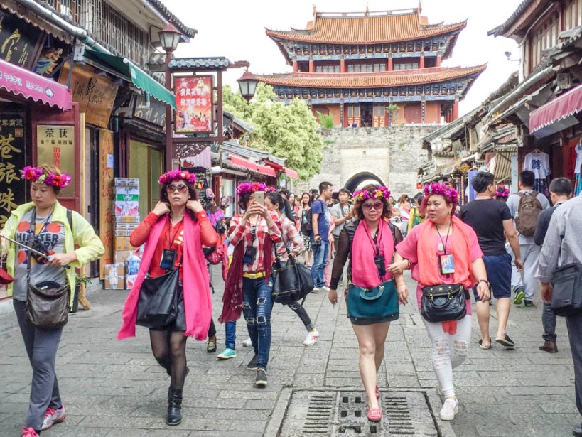 Gaggles of women in garlands marching through the old town