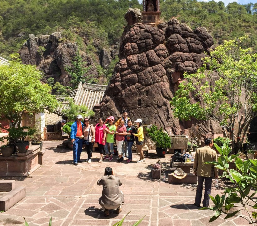 Ubiquitous gangs of local tourists pose in the temple courtyard
